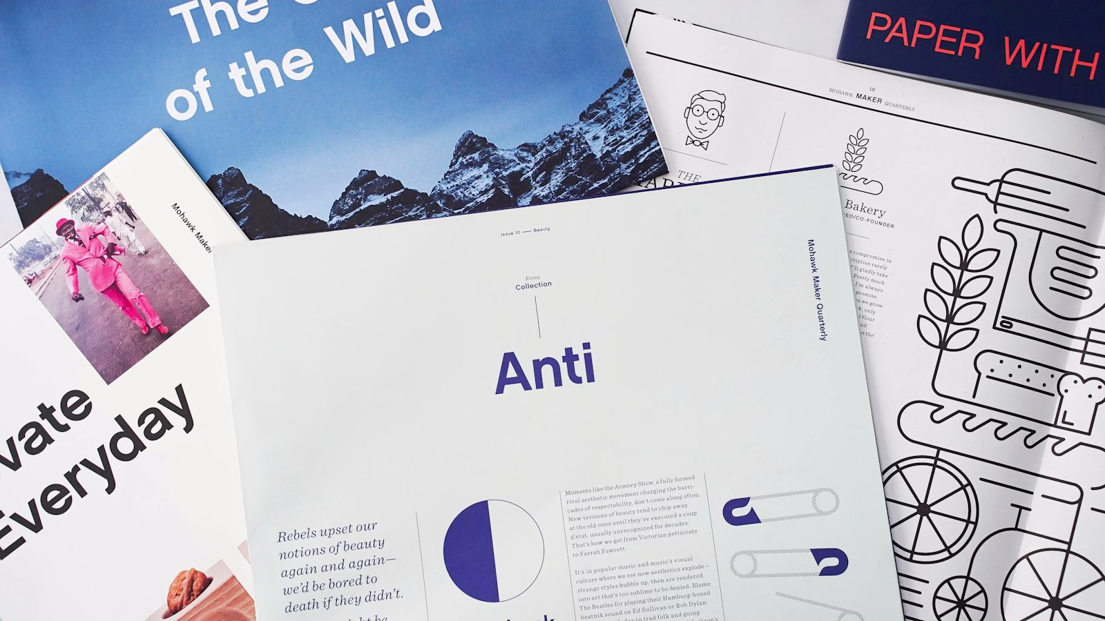 A flat lay of various design magazines and printed materials.